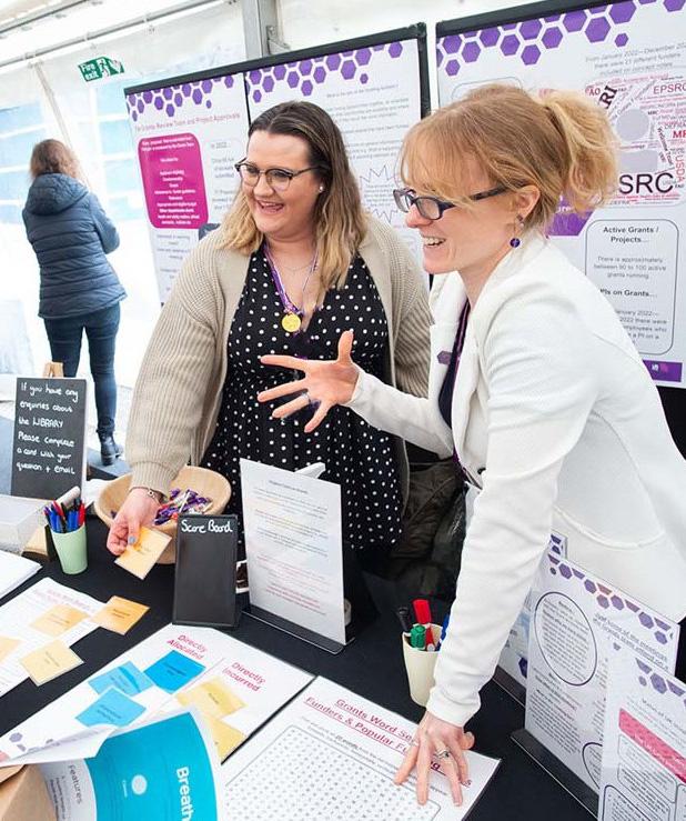 Lucy at a stand with a colleague